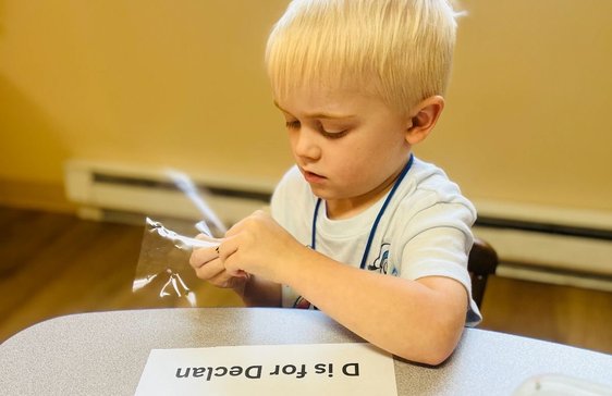 kid playing with teacher